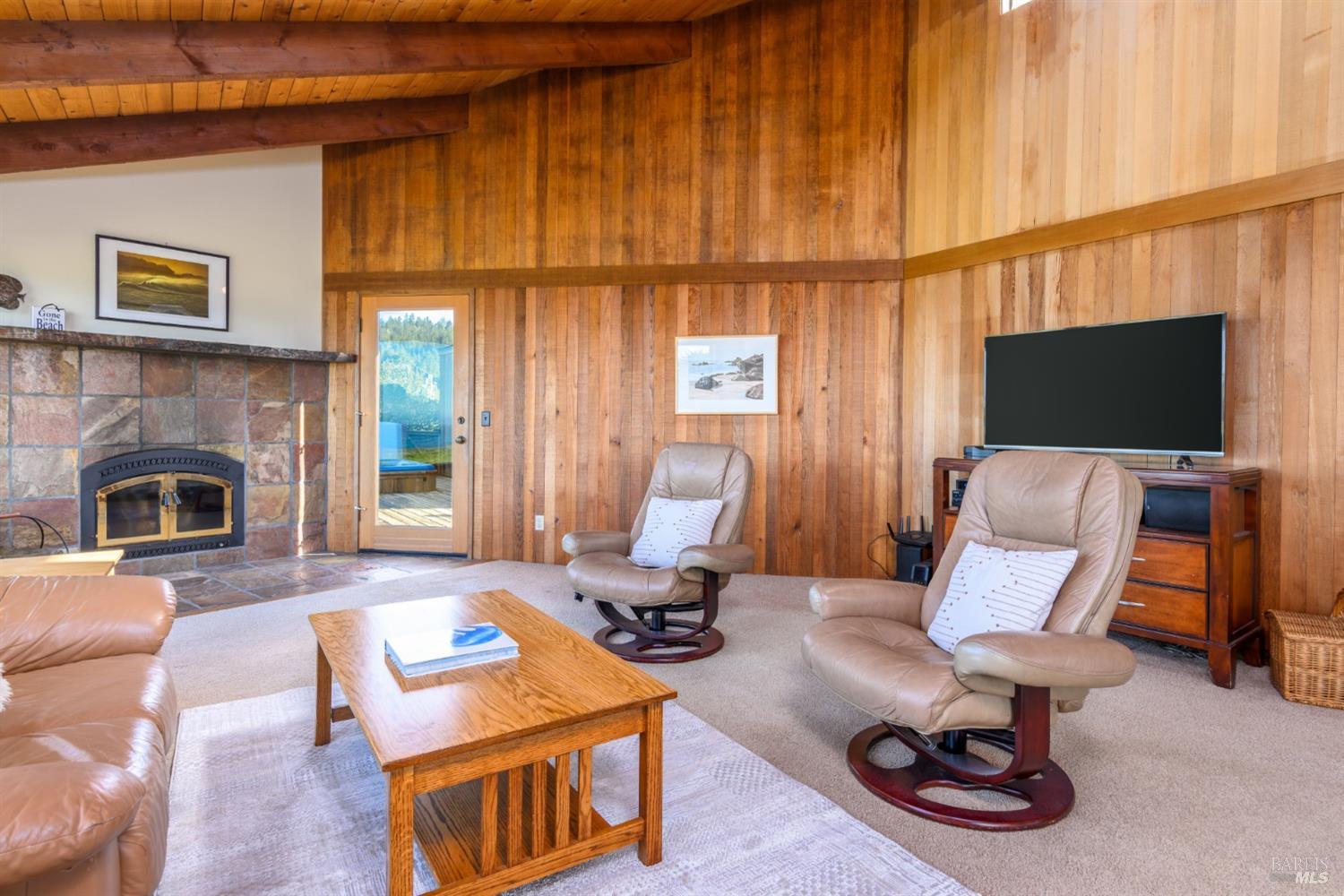 39153 Curlew Reach The Sea Ranch, CA 95497 - Photo 14 of 31 a living room with furniture a fireplace and a flat screen tv