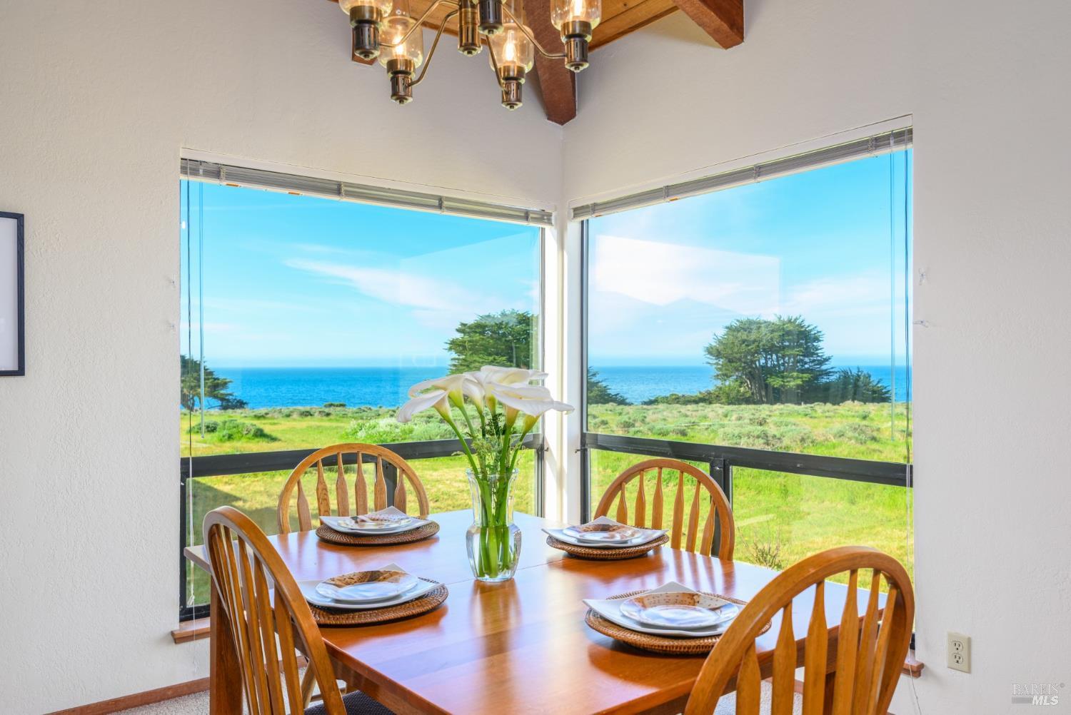 39153 Curlew Reach The Sea Ranch, CA 95497 - Photo 15 of 31 a dining room with furniture a kitchen view and wooden floor