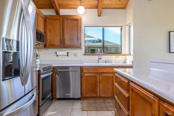 a kitchen with stainless steel appliances granite countertop a refrigerator stove and sink