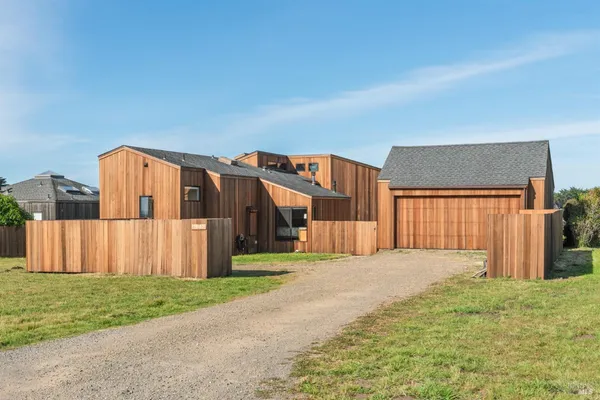 a view of a house with a yard and garage
