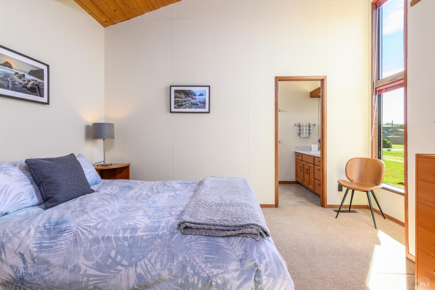 39153 Curlew Reach The Sea Ranch, CA 95497 - Photo 23 of 31 a bedroom with a bed and dresser with mirror