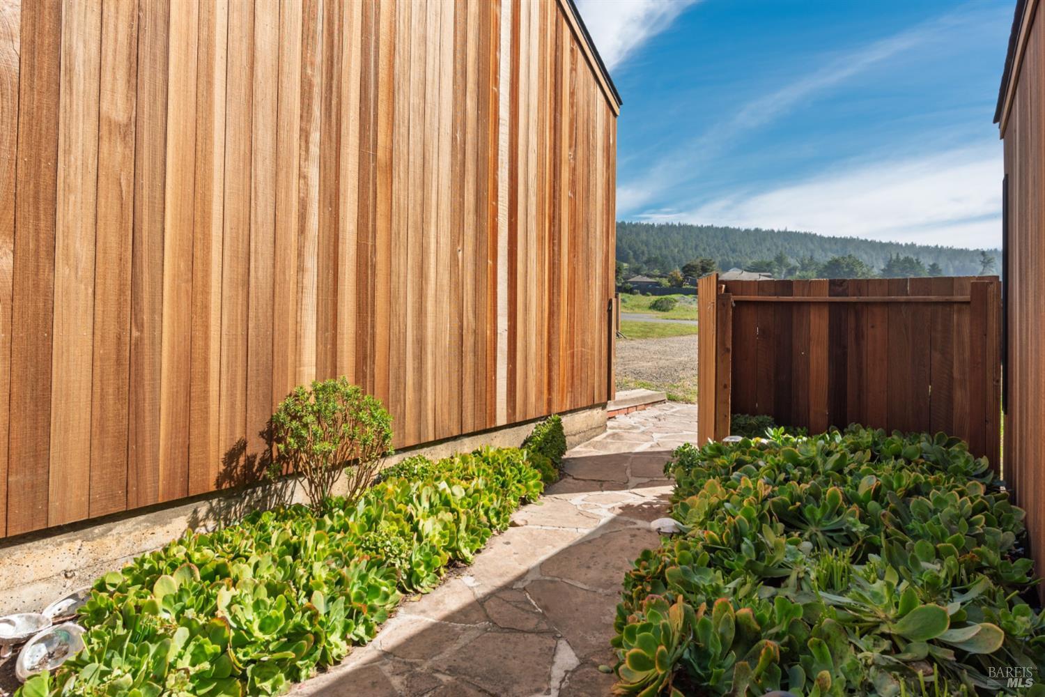 39153 Curlew Reach The Sea Ranch, CA 95497 - Photo 10 of 31 a bunch of flowers with wooden fence