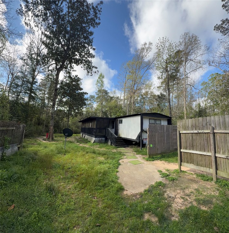 504 Bob Wills Road Livingston, TX 77351 - Photo 3 of 15 a backyard of a house with barbeque oven