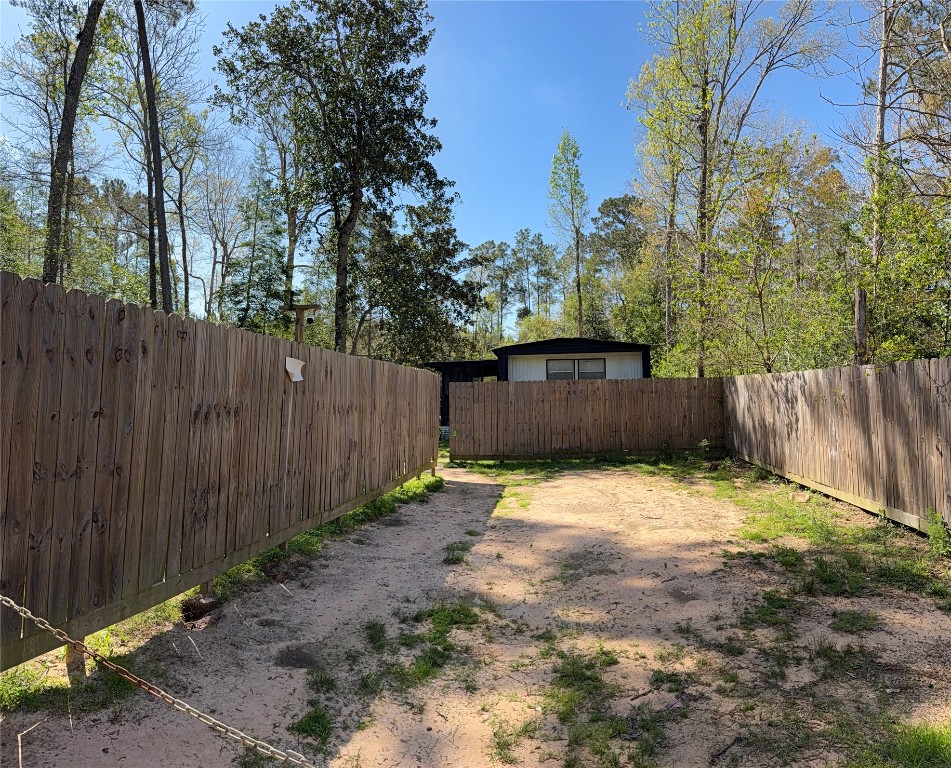 504 Bob Wills Road Livingston, TX 77351 - Photo 4 of 15 a backyard of a house