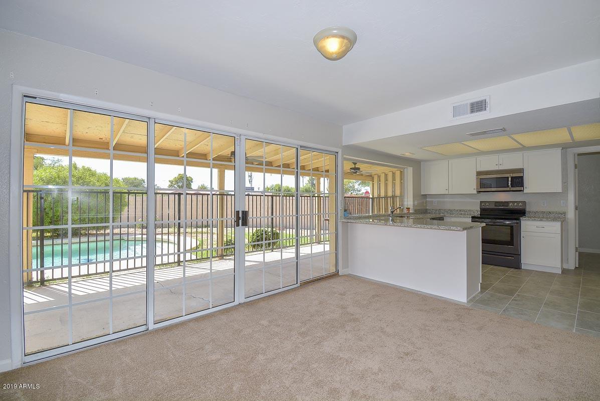 3935 West Calavar Road Phoenix, AZ 85053 - Photo 6 of 27 Family Room-Kitchen2