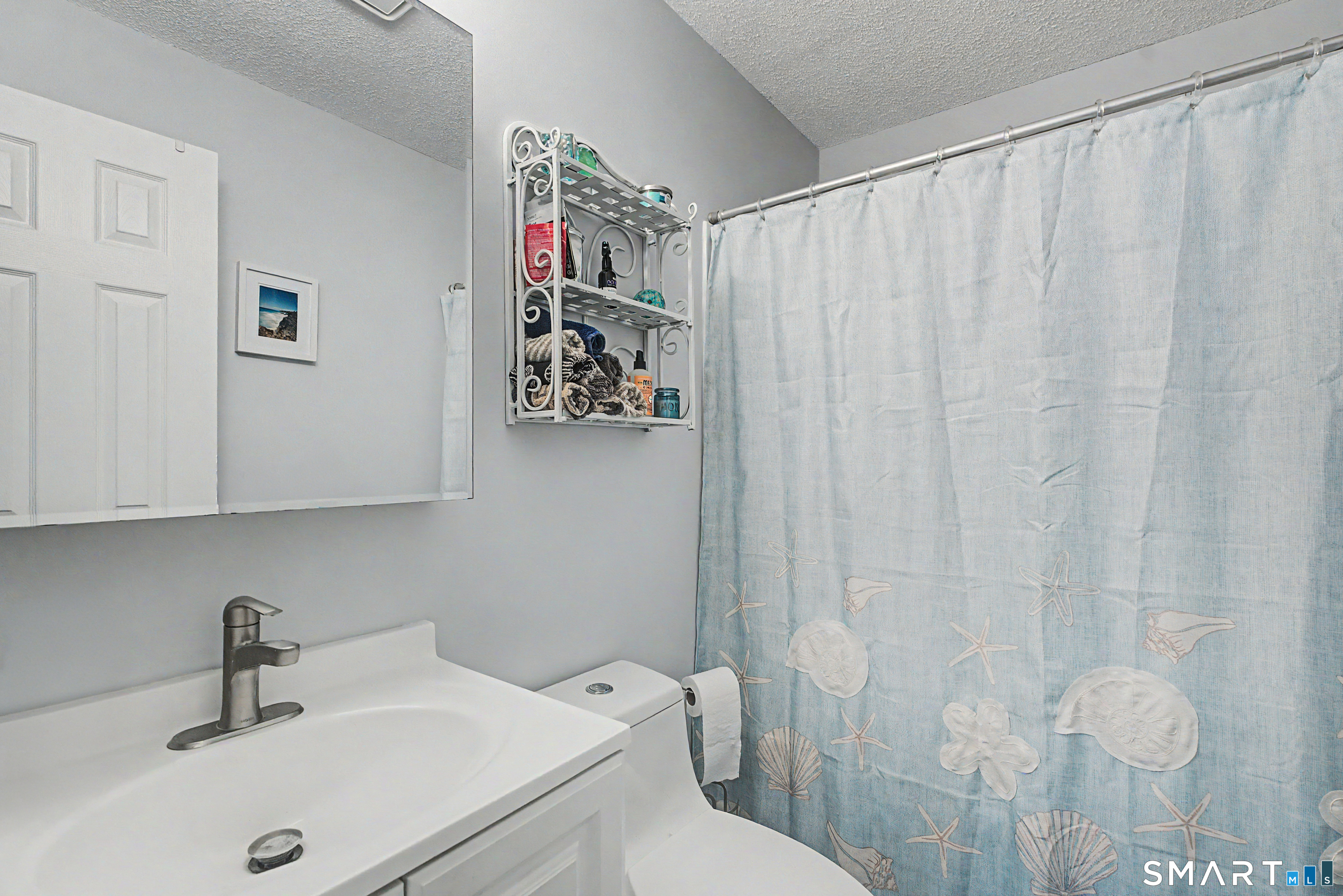 900 Mix Avenue, Unit 60 Hamden, CT 06514 - Photo 14 of 21 a bathroom with a sink and a mirror
