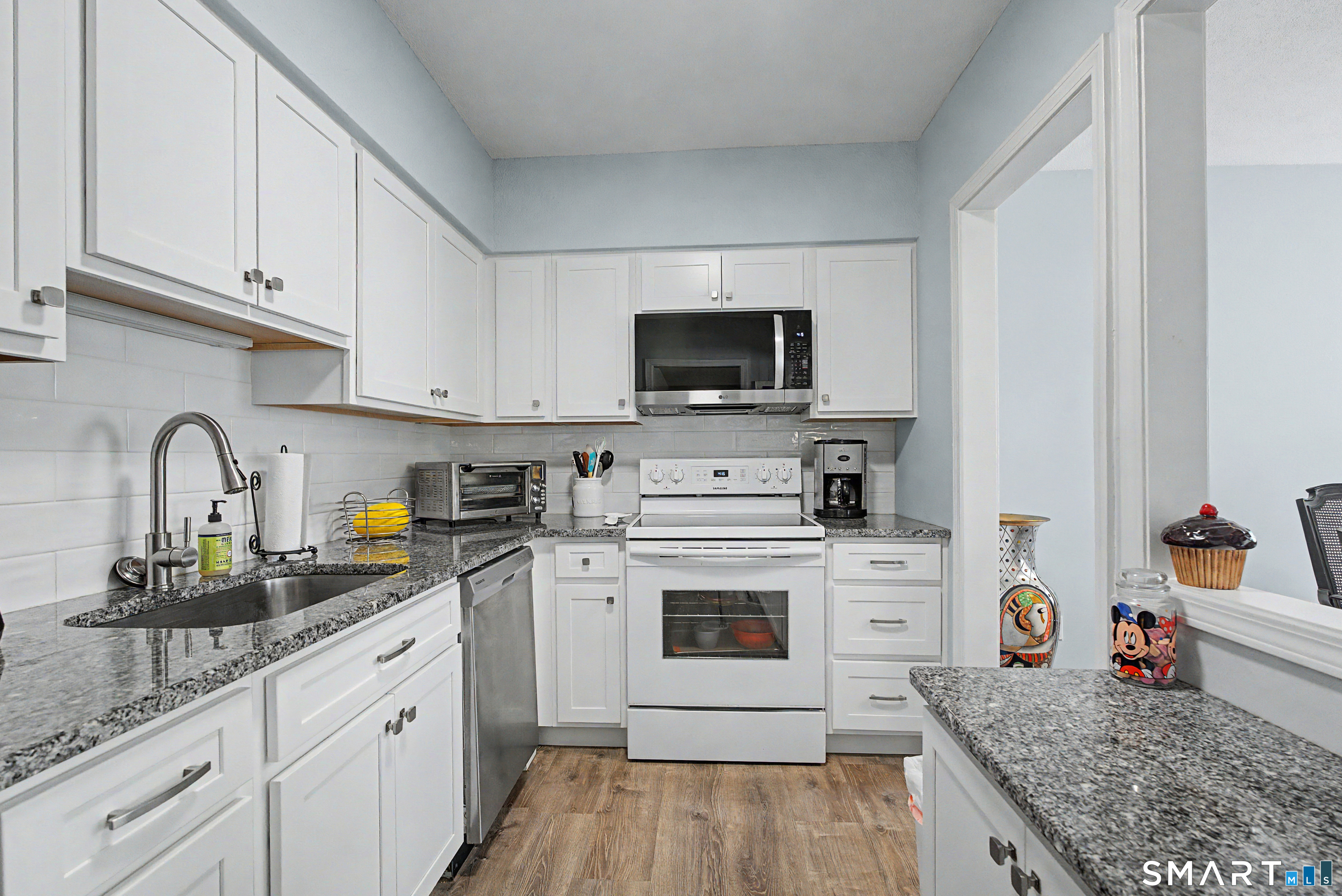 900 Mix Avenue, Unit 60 Hamden, CT 06514 - Photo 2 of 21 a kitchen with granite countertop a sink stainless steel appliances and white cabinets