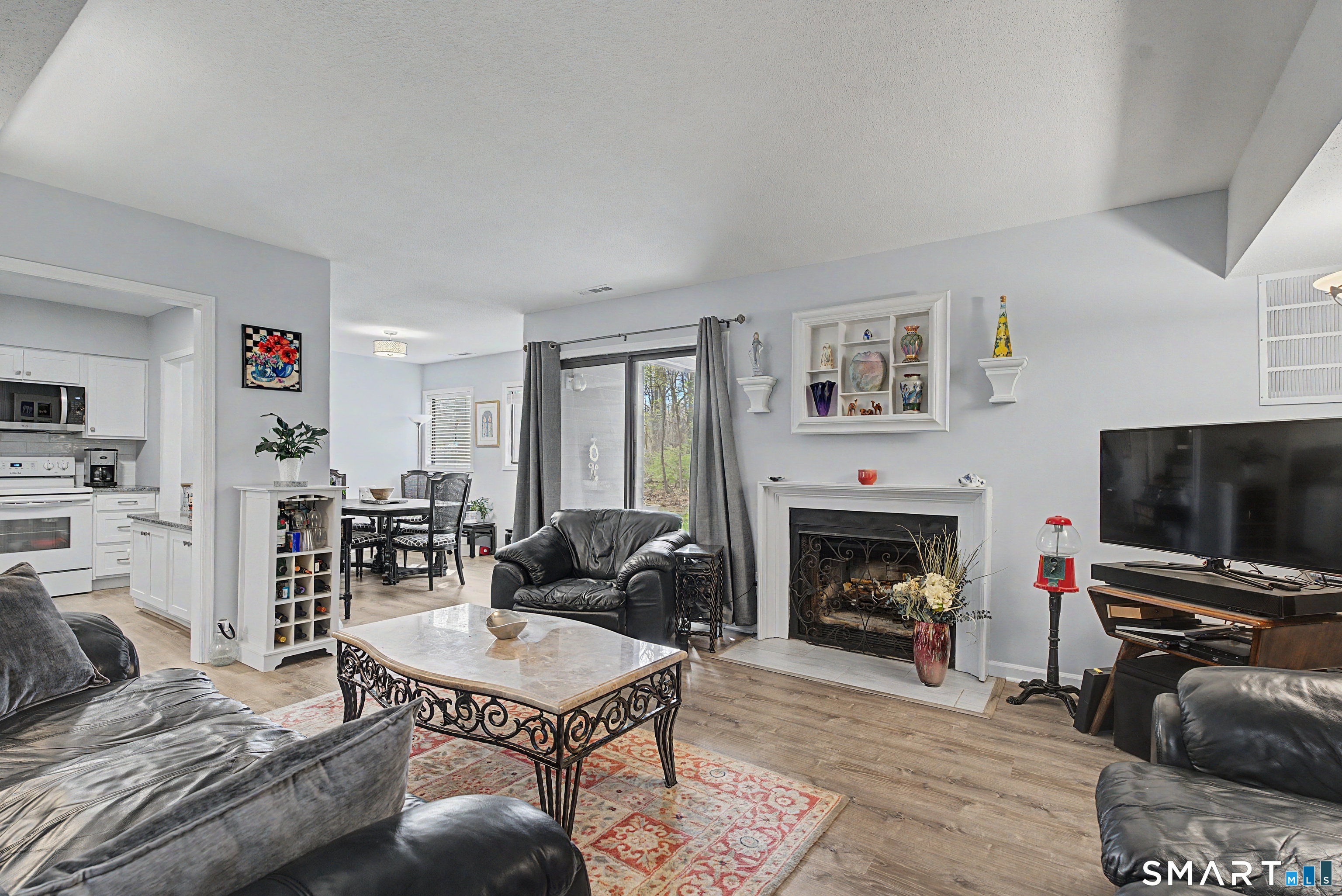 900 Mix Avenue, Unit 60 Hamden, CT 06514 - Photo 6 of 21 a living room with furniture a flat screen tv and a fireplace