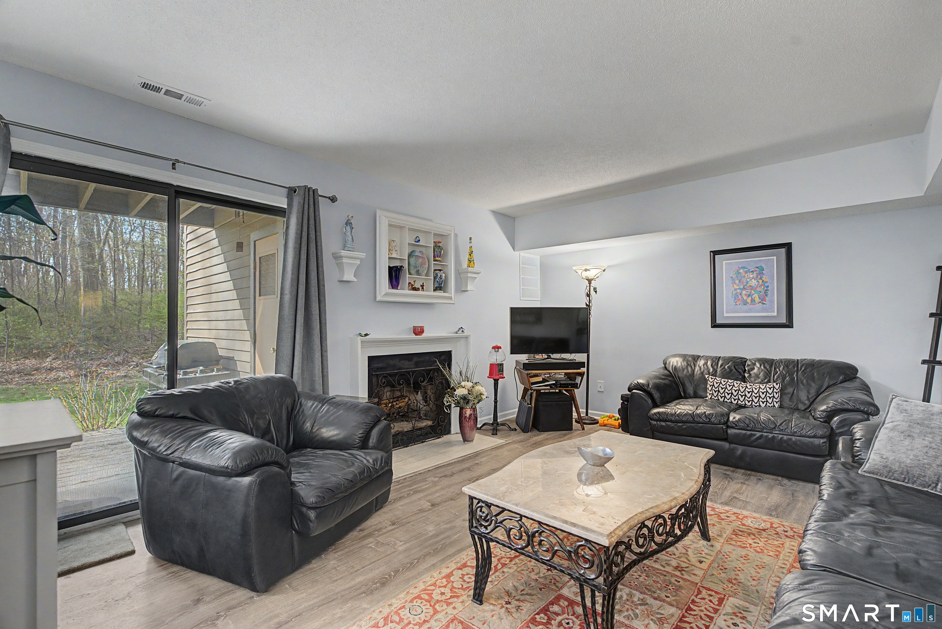 900 Mix Avenue, Unit 60 Hamden, CT 06514 - Photo 7 of 21 a living room with furniture a flat screen tv and a fireplace