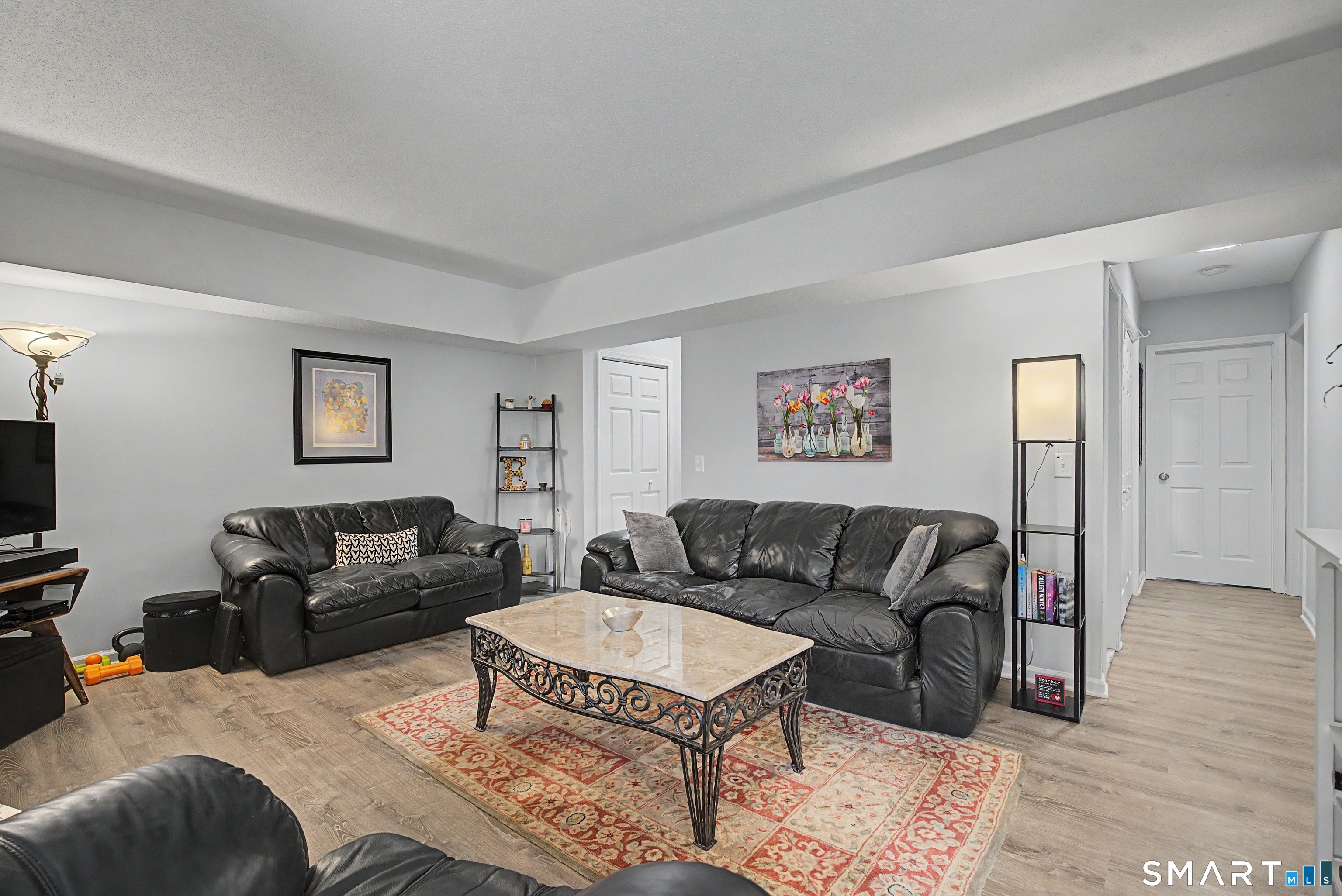 900 Mix Avenue, Unit 60 Hamden, CT 06514 - Photo 8 of 21 a living room with furniture and a flat screen tv
