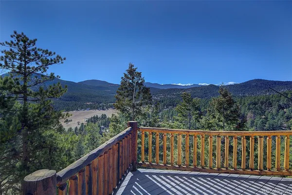 a view of a balcony with wooden fence and floor