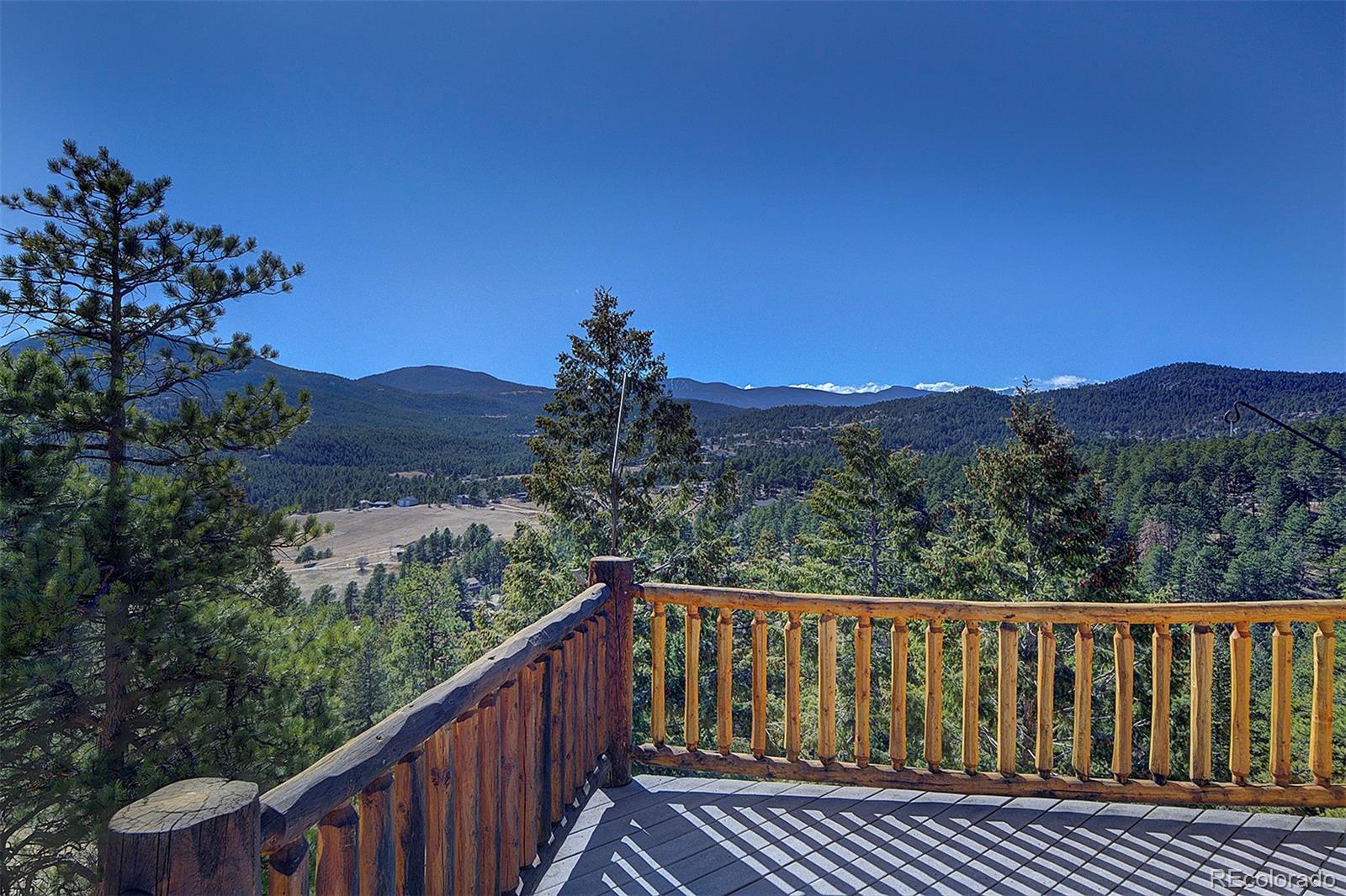 6561 Ridgeview Drive Morrison, CO 80465 - Photo 1 of 36 a view of a balcony with wooden fence and floor