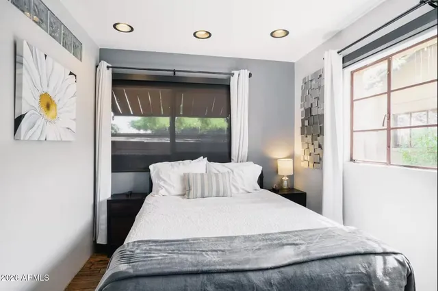 a bedroom with a bed and a window