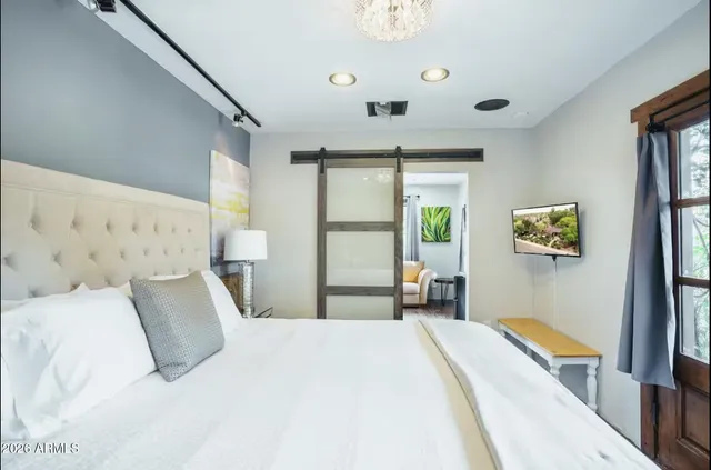 a bedroom with a large bed and a large window