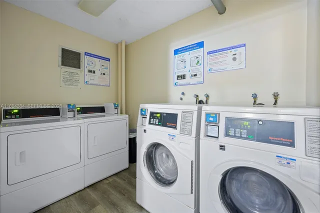 a utility room with cabinets dryer and washer