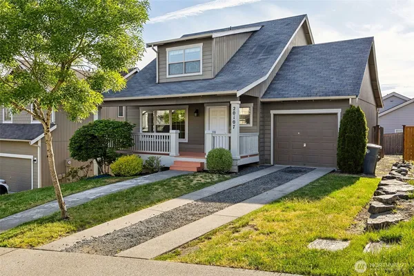 a front view of a house with a yard and garage