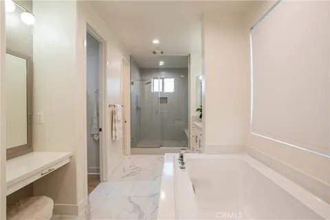 a bathroom with a tub shower and sink