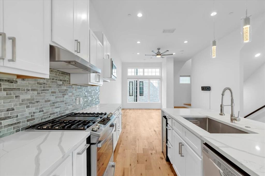 1910 Caddo Street, Unit A205 Dallas, TX 75204 - Photo 12 of 36 a kitchen with a sink a stove and a refrigerator