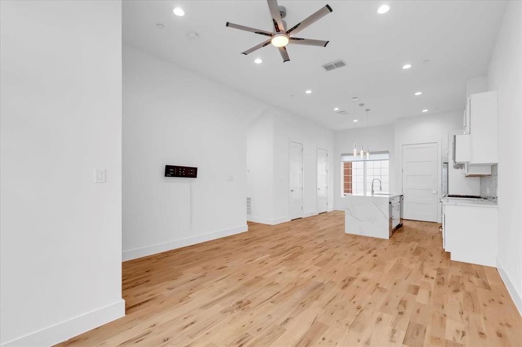 1910 Caddo Street, Unit A205 Dallas, TX 75204 - Photo 15 of 36 a view of empty room with wooden floor and fan