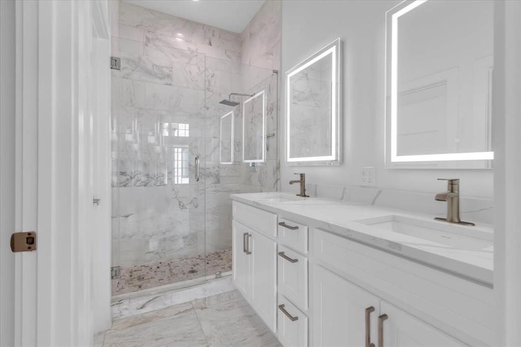 1910 Caddo Street, Unit A205 Dallas, TX 75204 - Photo 27 of 36 a bathroom with a shower sink and mirror