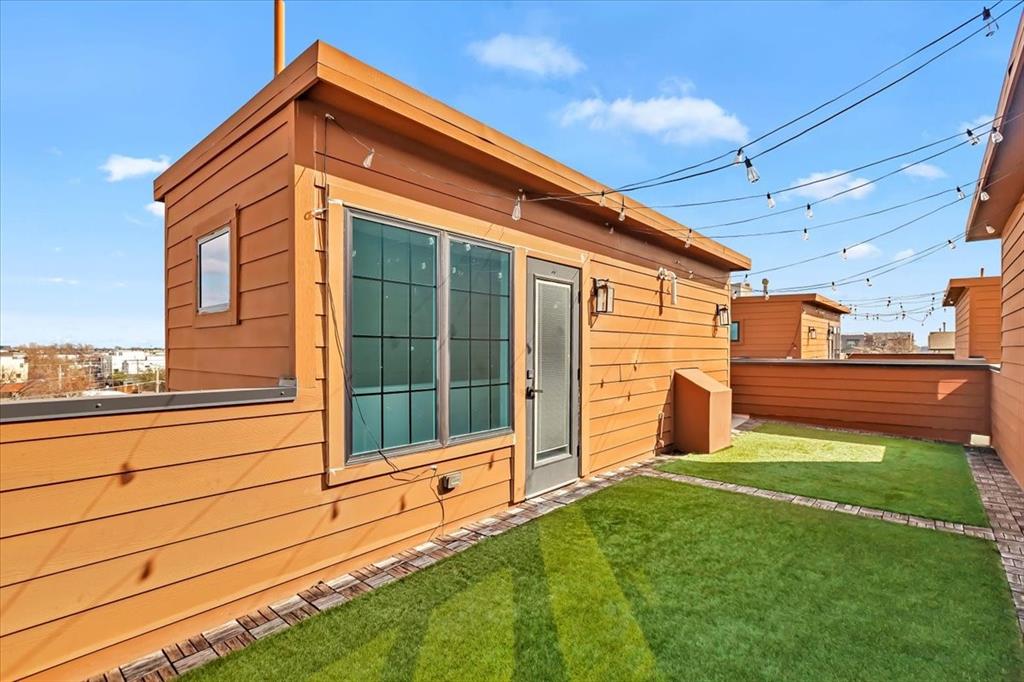 1910 Caddo Street, Unit A205 Dallas, TX 75204 - Photo 30 of 36 a front view of a house with a yard