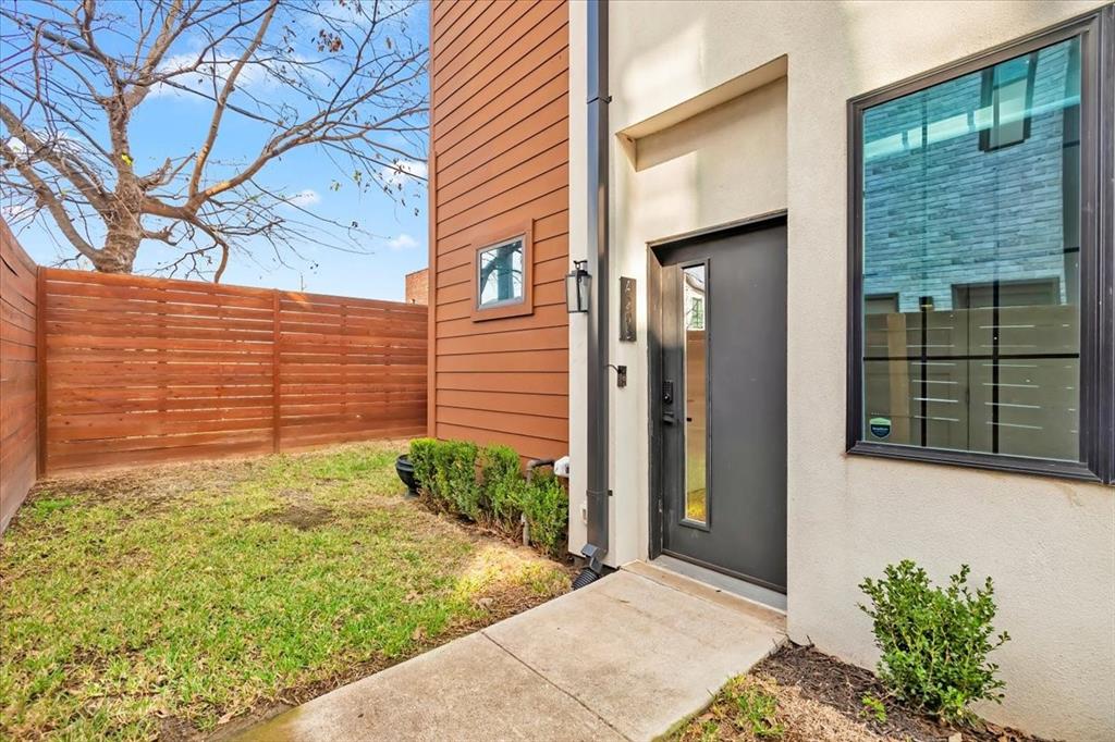 1910 Caddo Street, Unit A205 Dallas, TX 75204 - Photo 3 of 36 a view of yellow house with a large window and yard