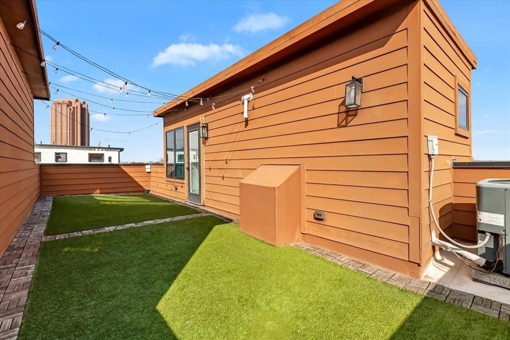 1910 Caddo Street, Unit A205 Dallas, TX 75204 - Photo 31 of 36 a front view of a house with a garden