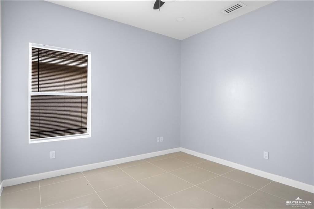2013 Stardust Lane, Unit 1 Edinburg, TX 78541 - Photo 5 of 17 Empty room with baseboards and light tile patterned floors