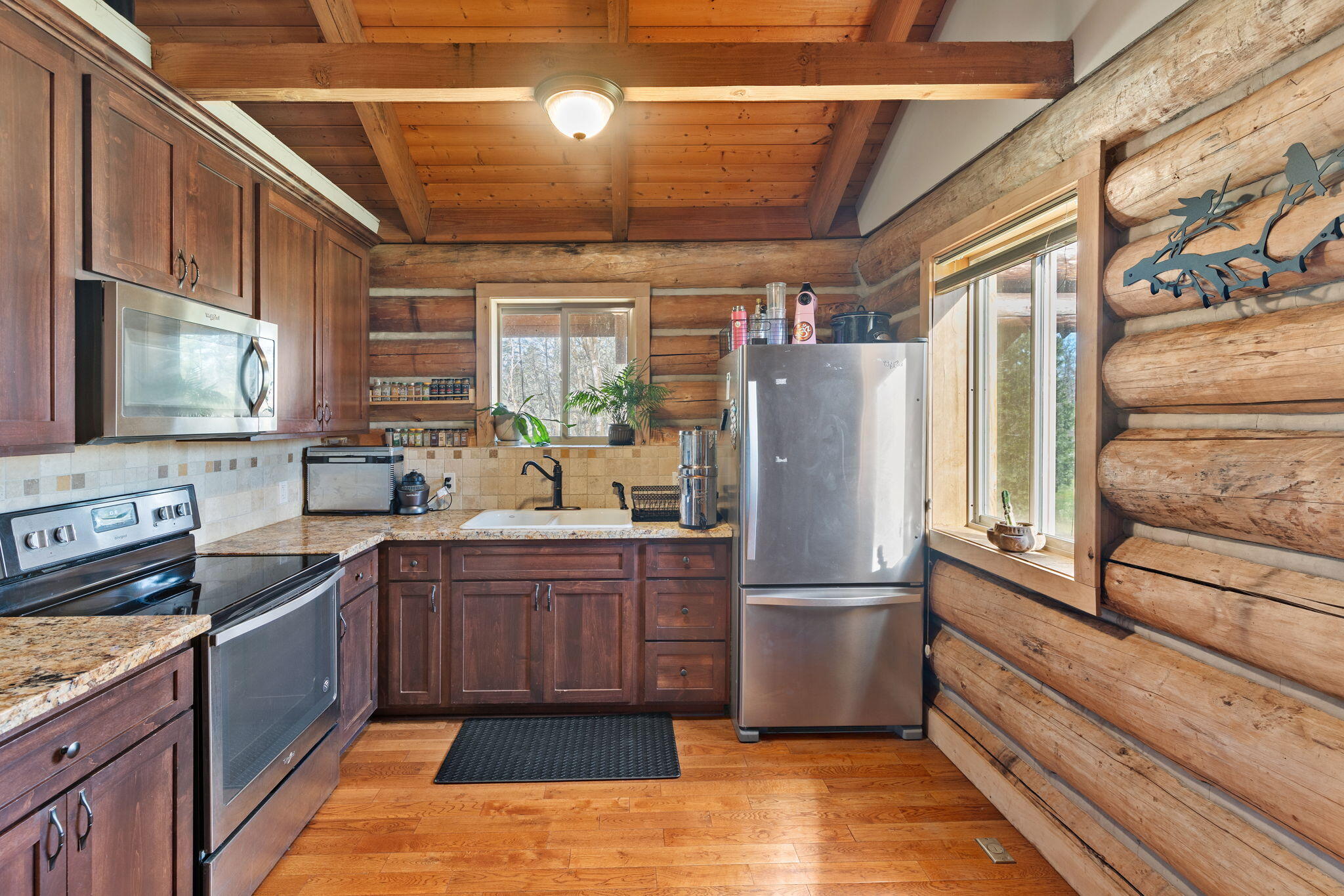 5737 Rockydale Road Cave Junction, OR 97523 - Photo 5 of 39 a kitchen with stainless steel appliances granite countertop a refrigerator and a stove top oven