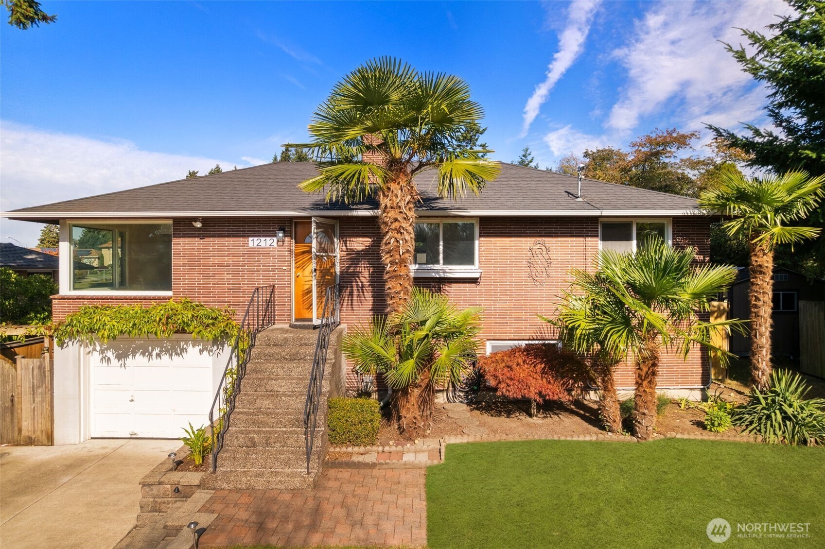1212 South 230th Street Des Moines, WA 98198 - Photo 2 of 32 a front view of a house with garden