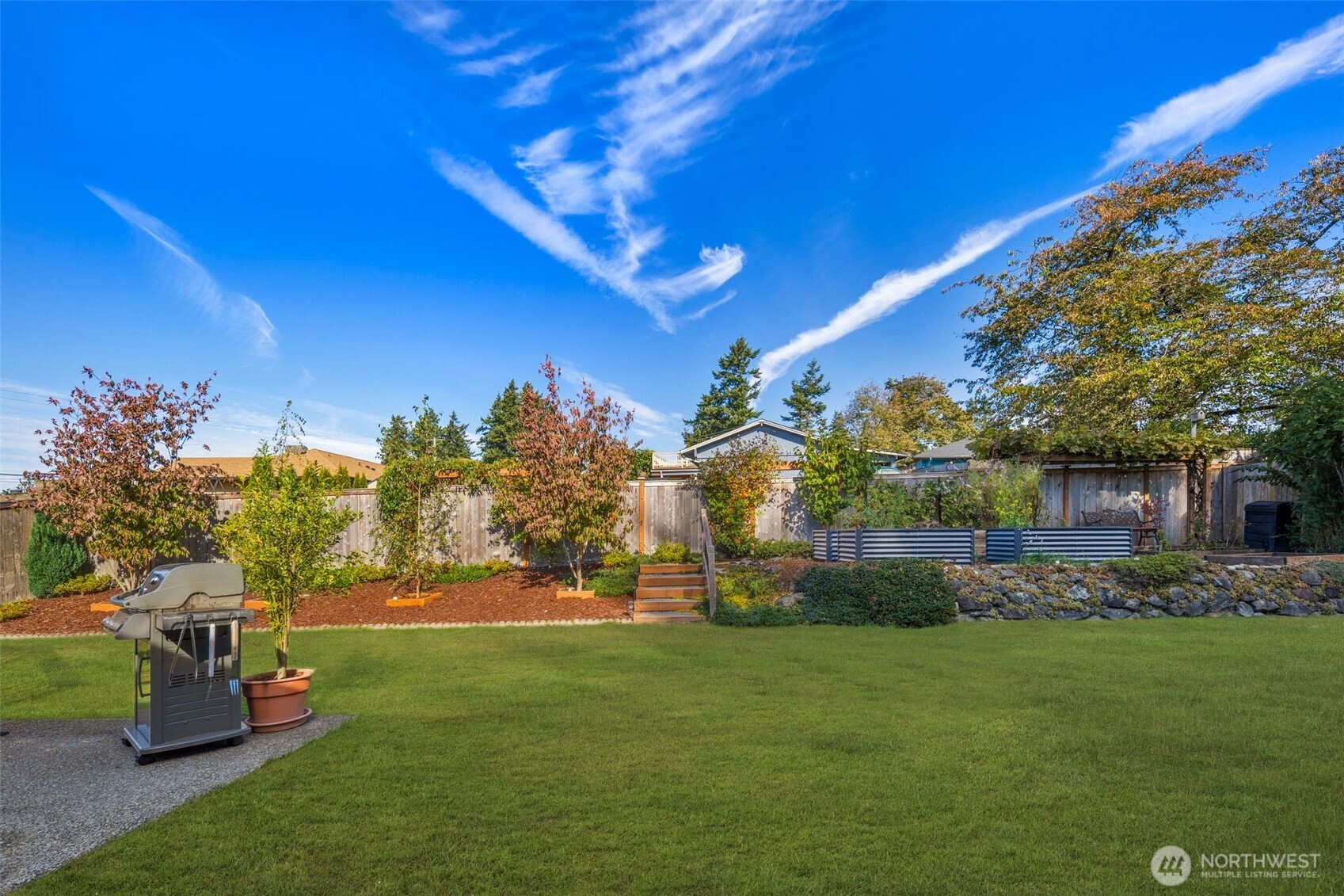 1212 South 230th Street Des Moines, WA 98198 - Photo 25 of 32 a view of a garden with a house