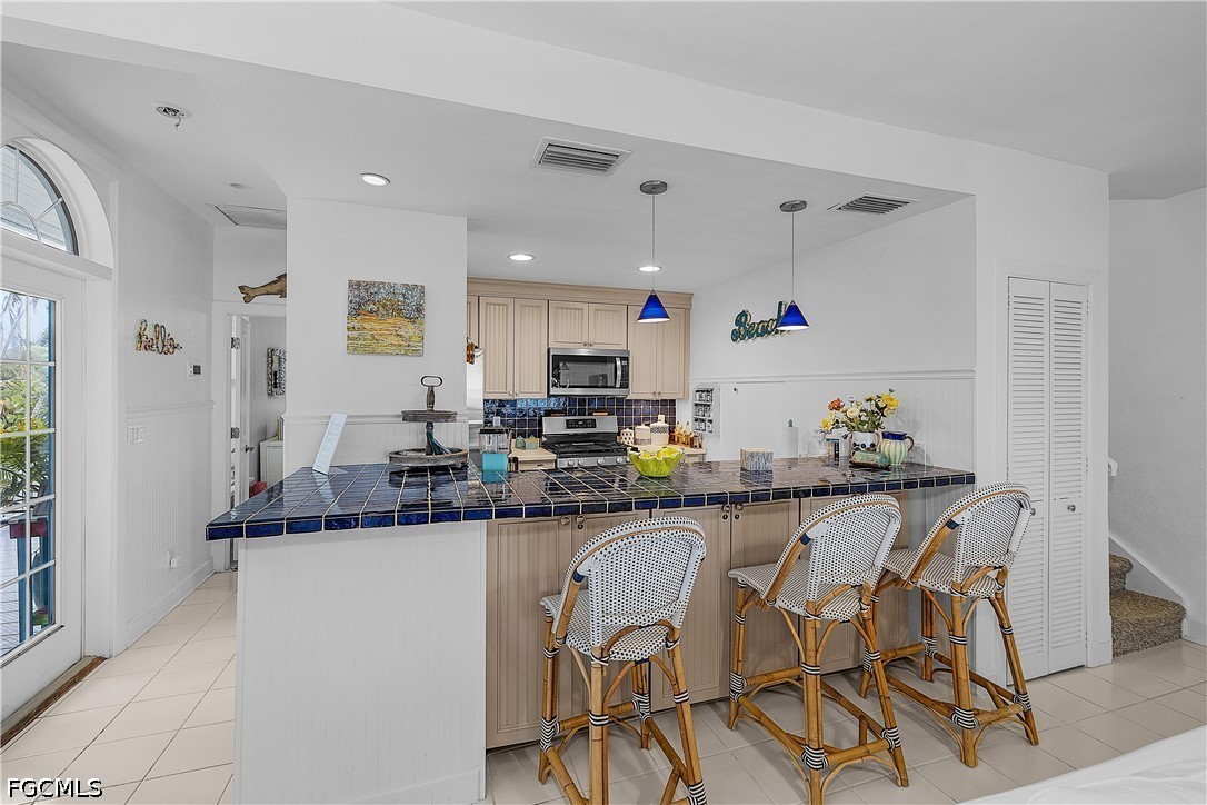 515 Useppa Useppa Island Bokeelia, FL 33922 - Photo 18 of 43 a kitchen with granite countertop white cabinets and chairs