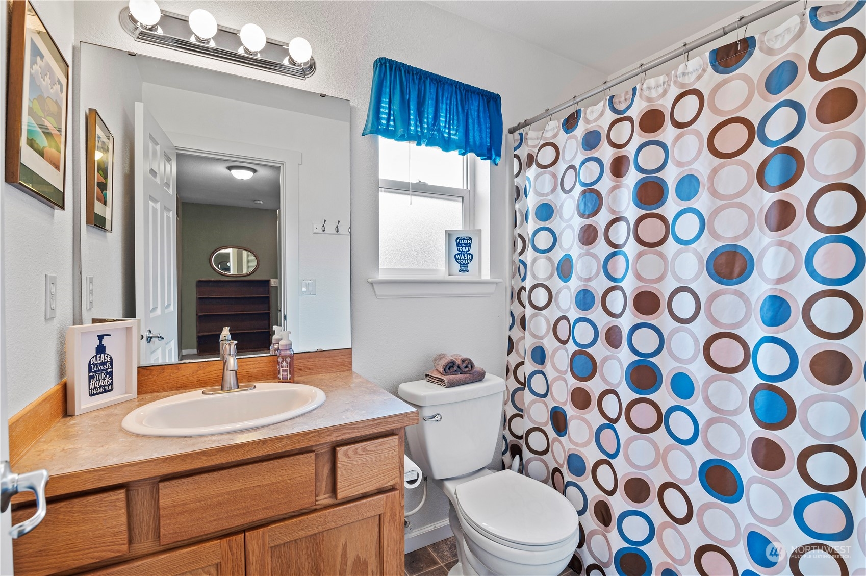 2502 97th Place Southeast Everett, WA 98208 - Photo 23 of 29 a bathroom with a sink a toilet a mirror and shower curtain