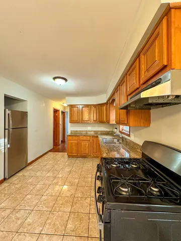 a kitchen with a stove and a refrigerator