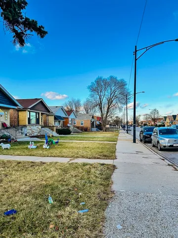 a view of a house with a big yard and potted plants