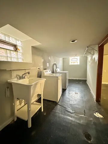 a living room with a table chairs and a kitchen view