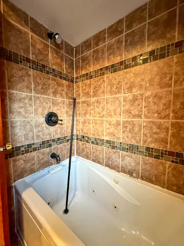 a bathroom with a tub and a shower