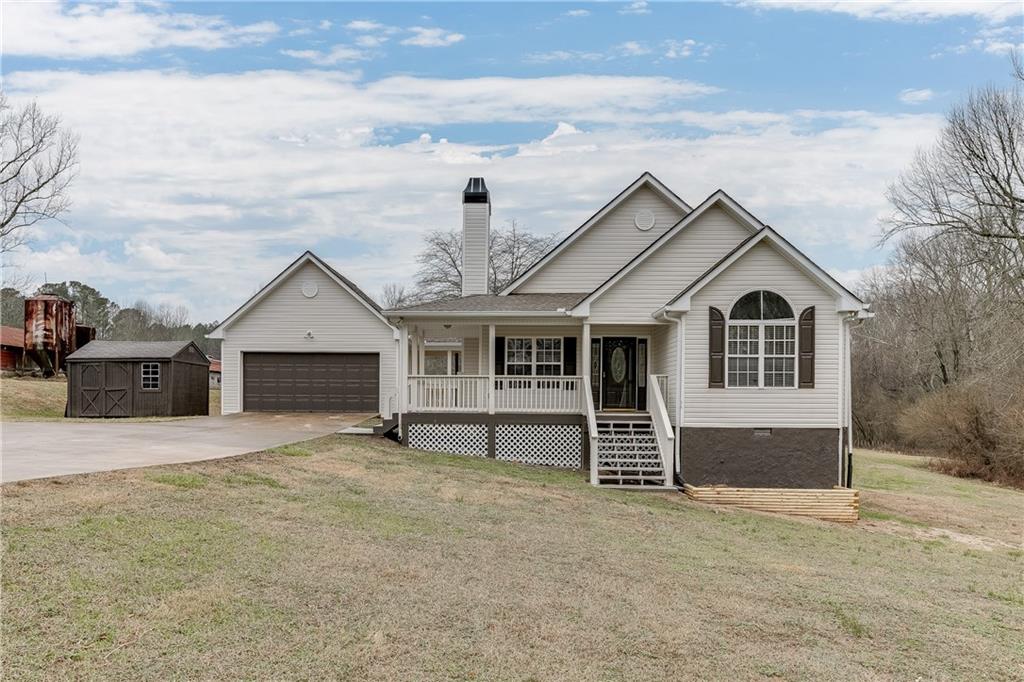 6655 Mt Tabor Road Cumming, GA 30028 - Photo 1 of 1 a front view of a house with a yard and garage