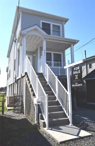 a kitchen with sink a refrigerator and wooden floors