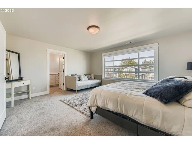 a bedroom with two beds and a large window