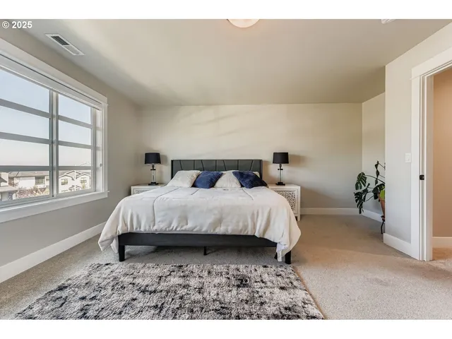 a bedroom with a bed with wooden floor