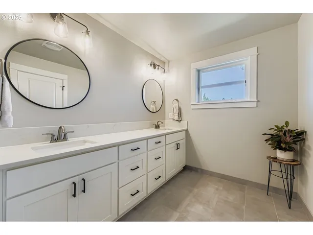 a bathroom with a double vanity sink and a mirror