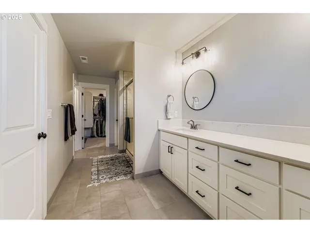 a bathroom with double vanity sink and a mirror