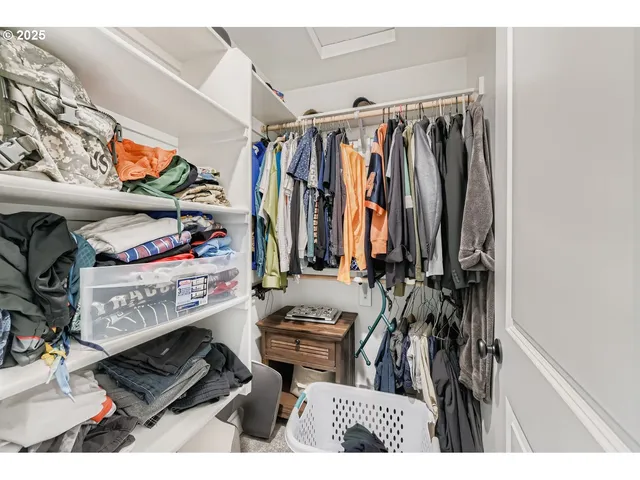 a view of walk in closet with clothes