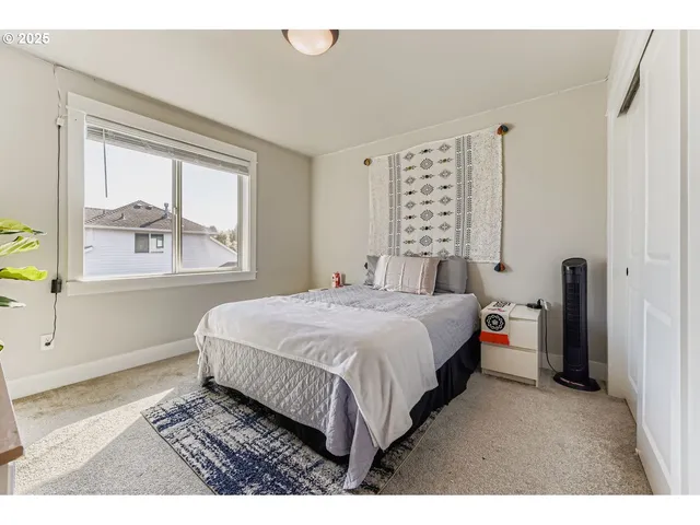 a bedroom with a large bed and a window