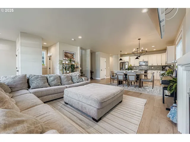 a living room with furniture and kitchen view