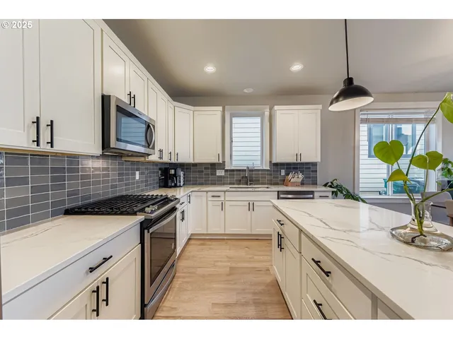a kitchen with a sink stove and cabinets