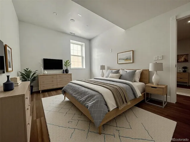 a bedroom with a bed and a flat screen tv