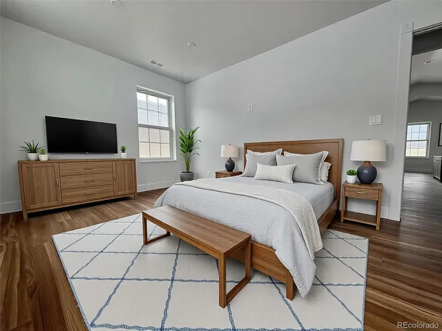 a bedroom with a bed and a flat screen television