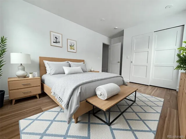 a bedroom with a bed and a lamp on table